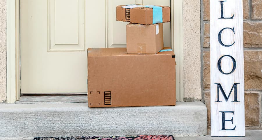 Deliveries on the front porch of a house with a welcome sign in Greenville